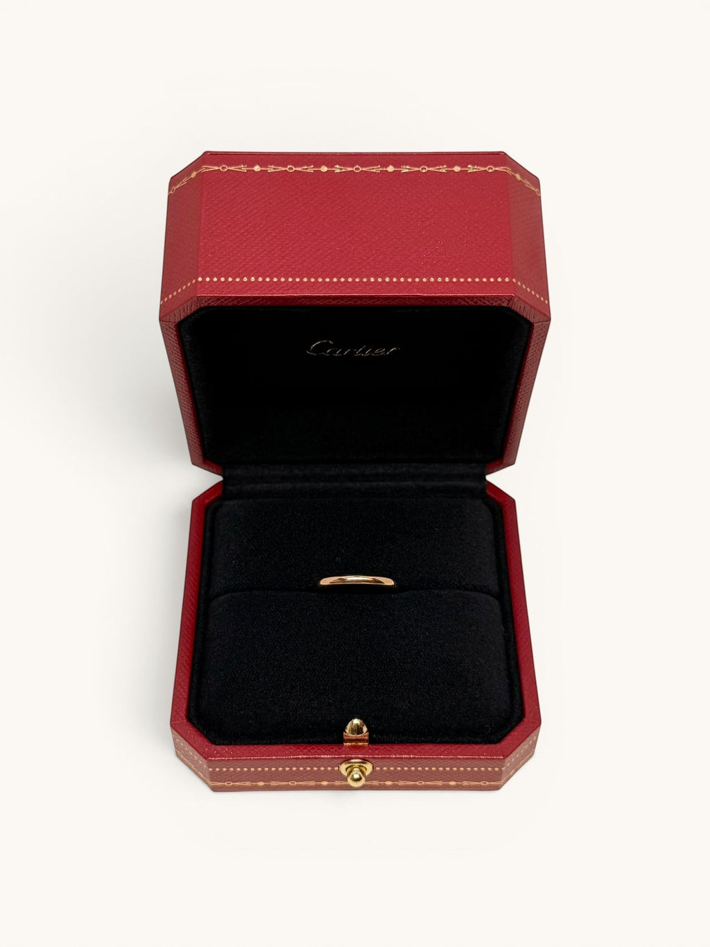 By the Hour Cartier 1895 wedding band in pink gold, 2.5mm wide, presented in a red Cartier ring box.