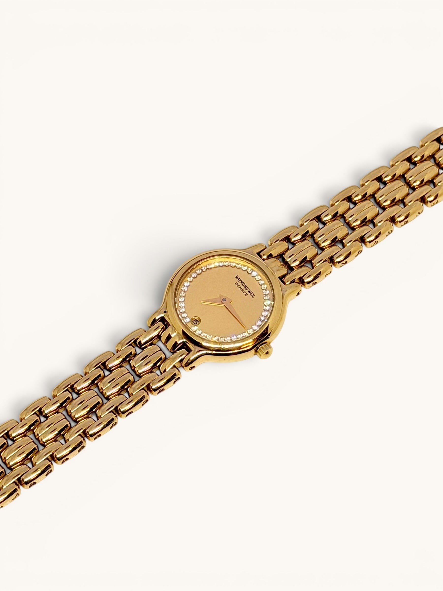 By the Hour vintage Raymond Weil Fidelio 9946 watch with gold-tone case, diamond bezel, and linked bracelet. Features a champagne dial with date window.