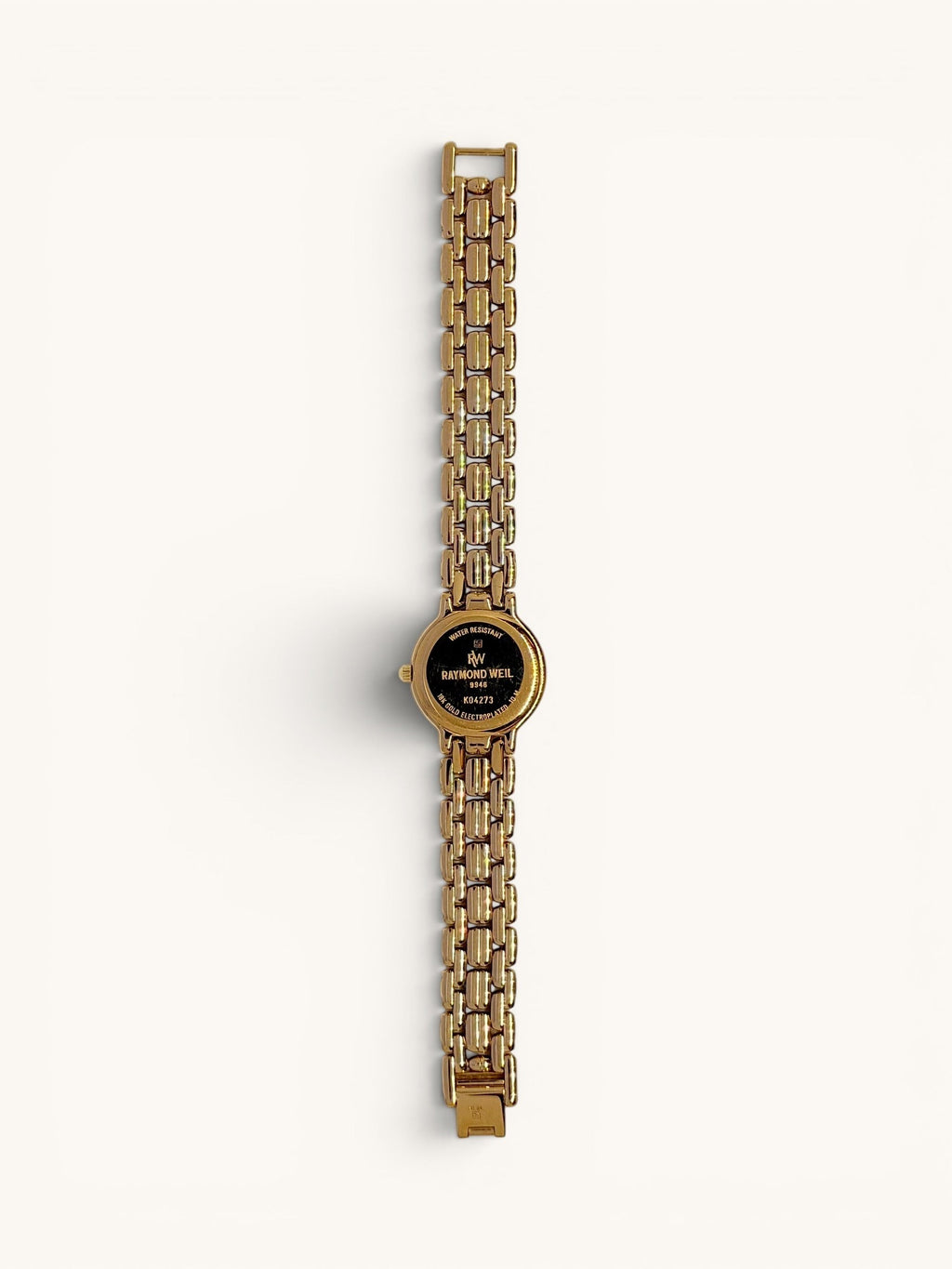 By the Hour vintage Raymond Weil Fidelio 9946 watch with gold-tone case, linked bracelet, diamond dial, and date window.