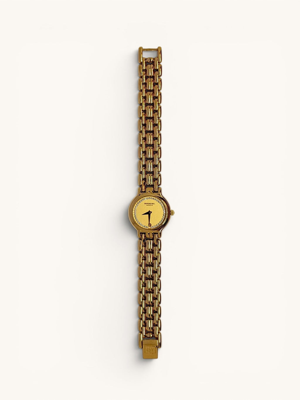 By the Hour vintage gold-tone Raymond Weil Fidelio watch with diamond dial and date window at 6 o'clock. Features a linked bracelet and Swiss quartz movement.